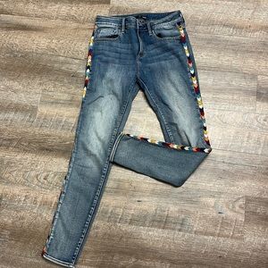 Aqua jeans with rainbow stitching on side